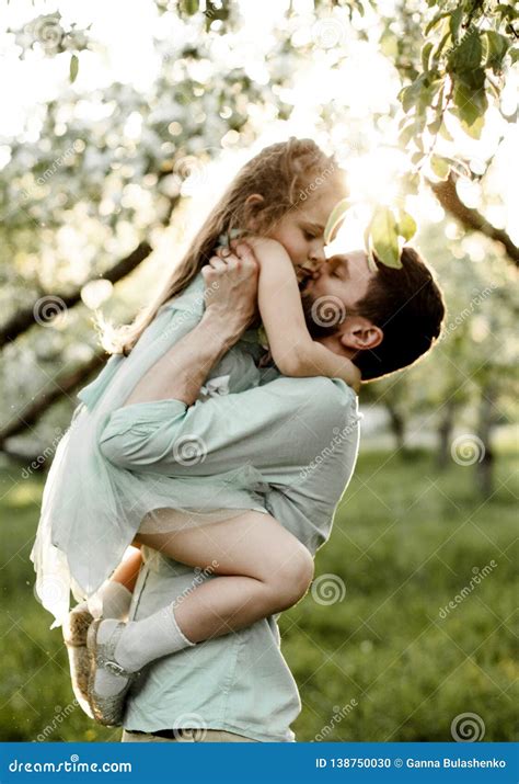 Father Kisses Daughter In Apple Orchard Stock Photo Image Of Green