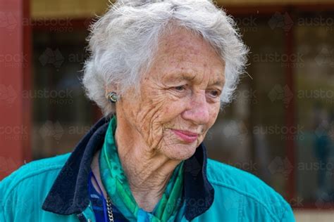 Image of head and shoulders of old lady with grey hair and wrinkled ...