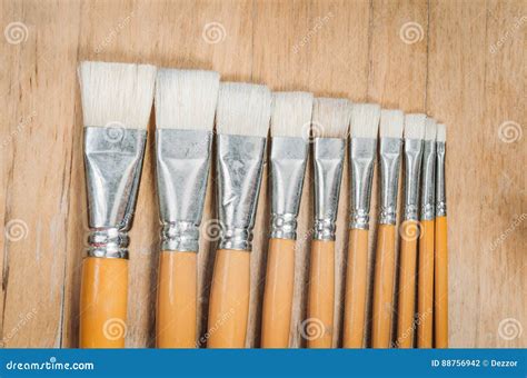 Bunch Of Old Artist Paintbrushes On Wooden Rustic Table Stock Photo