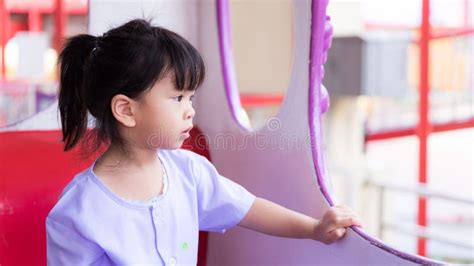 Cute Asian Girl Is Riding On Carousel In Amusement Park After Returning