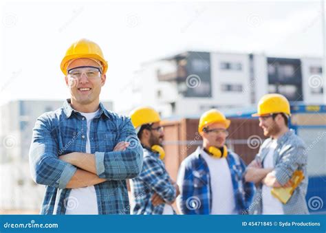 Group Of Smiling Builders In Hardhats Outdoors Stock Image Image Of