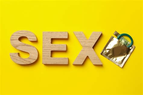 Word Sex Fait De Lettres En Bois Et Préservatif Sur Une Surface Jaune