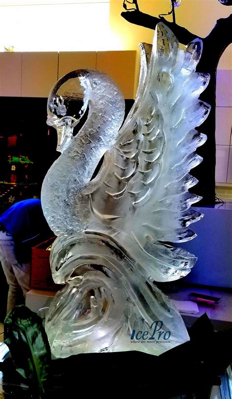 Elegant Swan Ice Sculpture Created From A Full Block Of Ice