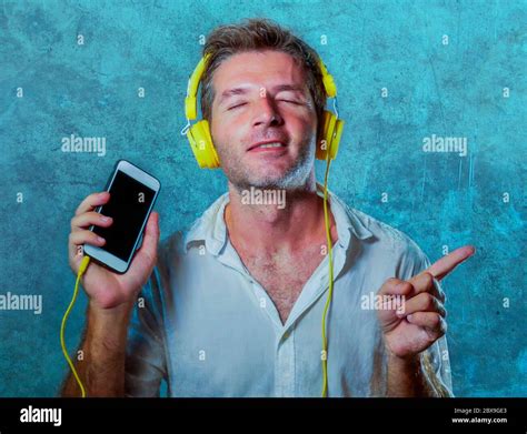 Young Attractive And Happy Cool Man Listening To Music Song With Yellow