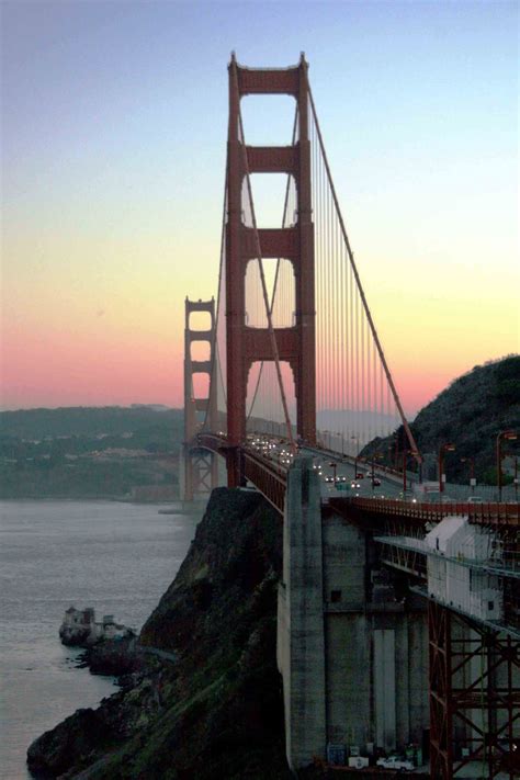 The international orange of the golden gate bridge glows in the evening light at sunset in the bay area. San Francisco - Top Ten City