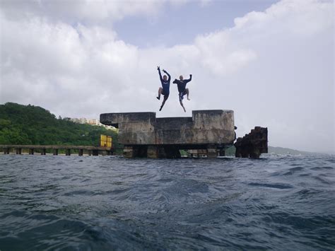 A dive instructor jumps into the ocean at crash boat beach. Simplicity: Aguadilla, Puerto Rico (Playa Crash Boat ...