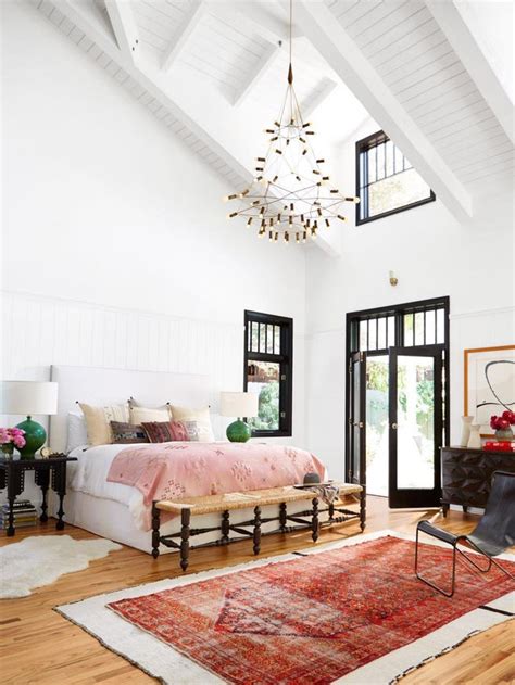 Light Filled Bedroom Features A High Vaulted Ceiling And Bold Black