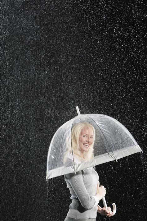 Smiling Businesswoman Standing Under Umbrella During Rain Stock Image