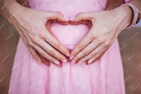 Premium Photo Heart Shaped Hands Of Pregnant Woman And Her Husband