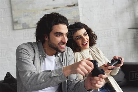 Smiling Young Couple Playing Video Game At Home Stock Photo Dissolve