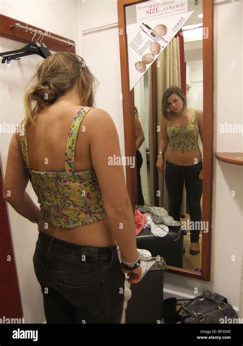 Teenage Girl Trying On Clothes In Changing Room Stock Photo Alamy