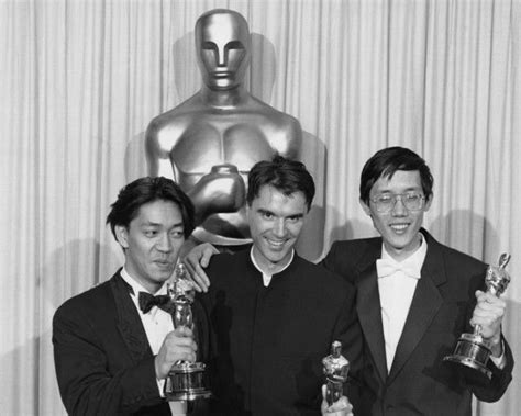Three Men In Tuxedos Pose With Their Oscars Trophies At The Academy