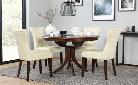 Playing games, helping with homework or just lingering after a meal, they're where you share good times with family and friends. Hudson Round Dark Wood Extending Dining Table and 4 Chairs Set (Bewley Ivory) | Furniture Choice