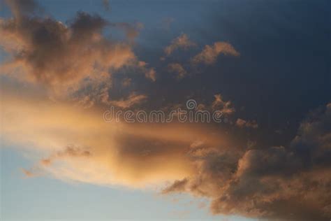 A Beautiful Evening Blue Sky At Sunset With Flaming Bright Light Clouds