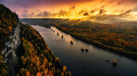 Aerial View Of River And Forest With Background Of Sunset Sky With
