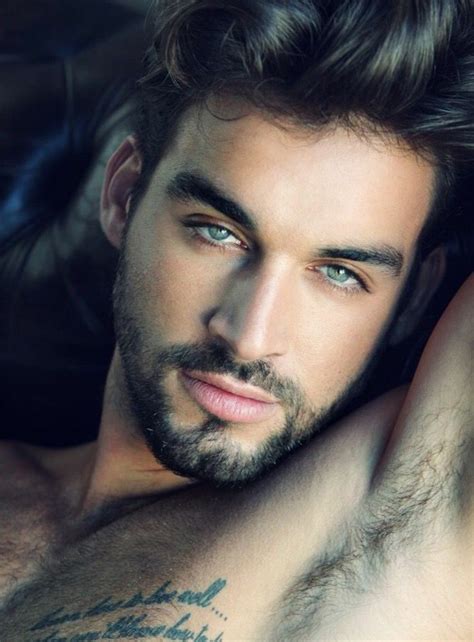 A Close Up Of A Man With Blue Eyes