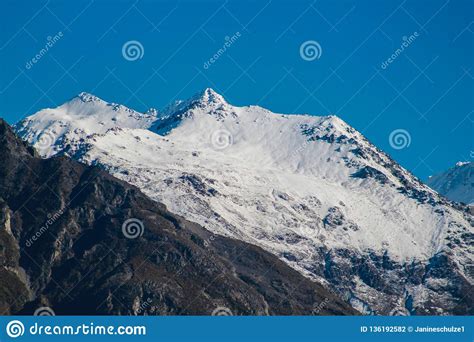 Snow Capped Mountain Peak With Clear Blue Sky Stock Photo Image Of