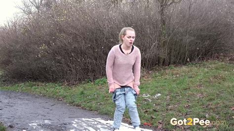 Debora Debora Clothed Girl Pulls Down Her Pants To Pee In A Muddy Puddle On A Path Jeans Sandals