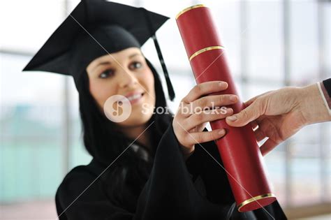 Young Female Graduating And Receiving Diploma At University Royalty