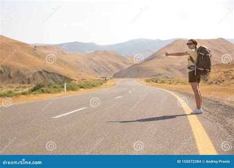 Hitchhiker Traveler Woman On The Road In Sunset Girl Traveler Hiker On