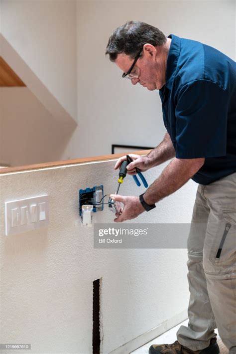 Electrician Installing Light Switch High Res Stock Photo Getty Images