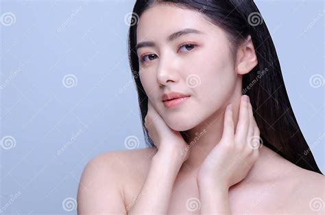 Beauty Portrait Of A Young Beautiful Woman With Hand On Her Neck