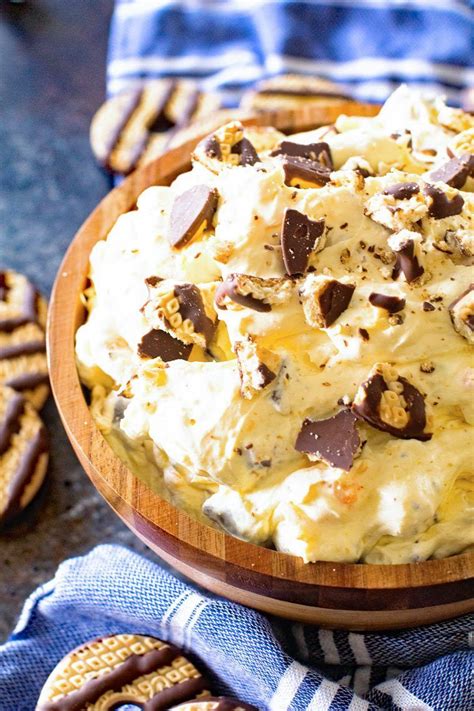 A Wooden Bowl Filled With Ice Cream And Chocolate Chips On Top Of A