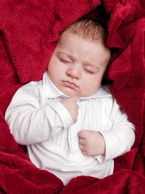 Lovely 3 Months Baby Sleeping Bed Covered Red Blanket Stock Photos