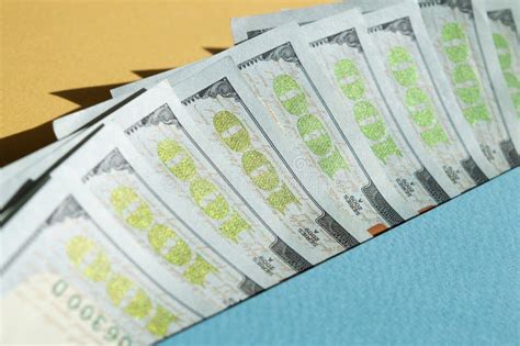 Nine Bills Of 100 Dollar On The Yellow And Blue Background Conceptual
