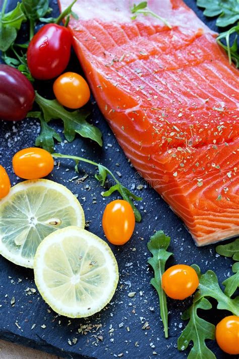 Fresh Raw Salmon Fillet With Aromatic Herbs And Spices Stock Photo
