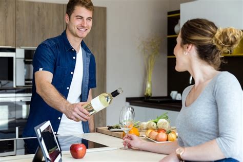 Premium Photo Handsome Young Man Opening Wine Bottle While His Wife