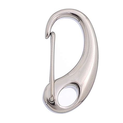 A Metal Hook That Is On The Side Of A White Wall And Has An Oval Handle