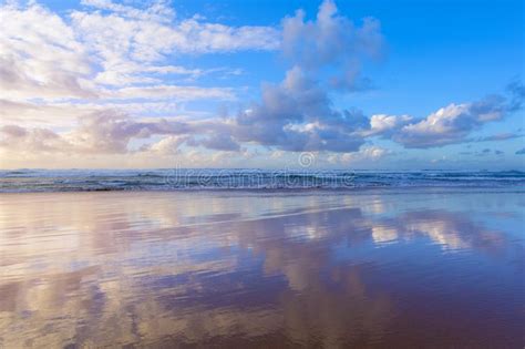 Beautiful Scene Cloudy Blue Sky Reflected On Beach Wet Sand Stock Photo