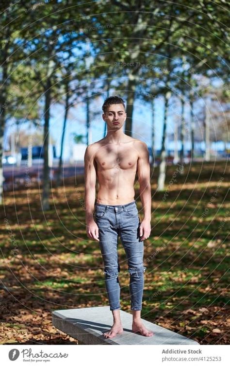 Shirtless Fit Man Standing In Park A Royalty Free Stock Photo From