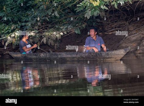 Locals Paddling A Dug Out Canoe In A Creek Off Of Napo River Yasuni