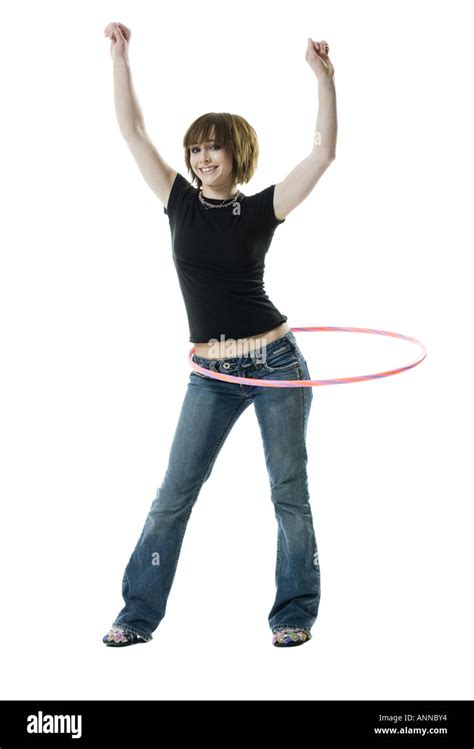 Portrait Of A Teenage Girl Spinning A Hula Hoop Around Her Waist Stock