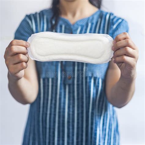 female`s hygiene products woman in medical gloves holding sanitary pads against white