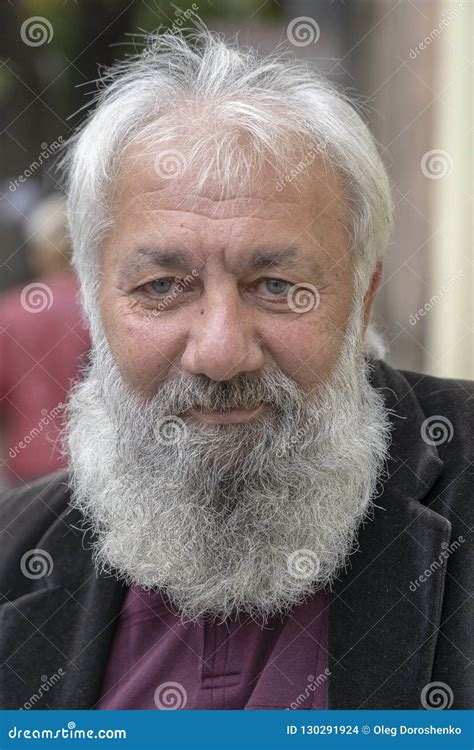 Portrait Of Old Man With A Gray Beard In A Russian Orthodox Church In