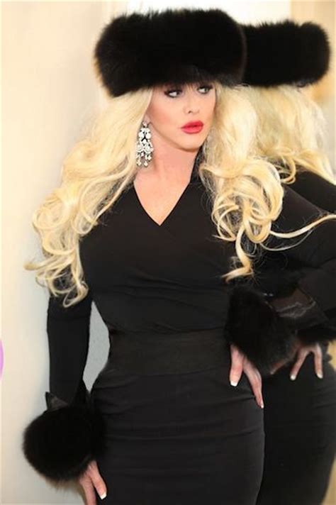 blond russian hypnosis mistress in wearing black fur hat and matching black fur cuffs fashion