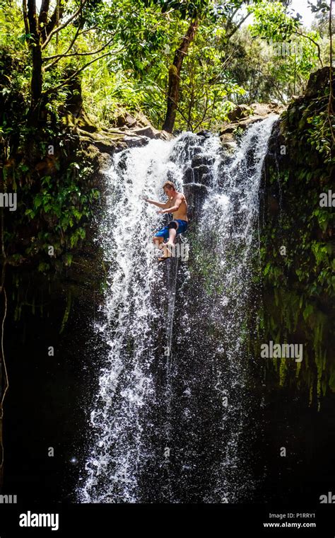 Young Man Jumps From A Waterfall Hana Maui Hawaii United States Of