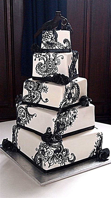A black and white wedding cake with simple ribbons and a crystal spray topper is a chic, modern look perfect for a winter wedding because the topper a white fondant wedding cake is the perfect palette for black stenciling. black and white henna wedding cake with chocolate crows ...