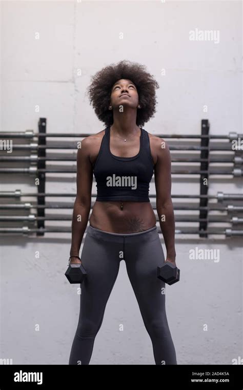 Black Woman Doing Bicep Curls Stock Photo Alamy