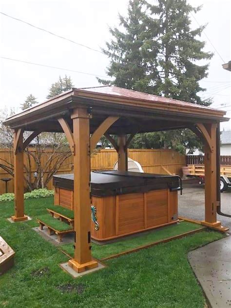 A Wooden Gazebo With A Hot Tub In The Middle Of It On Some Grass