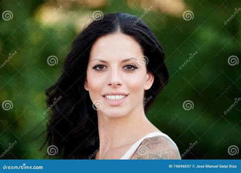 beautiful brunette girl relaxing in the park stock image image of female adult 74696037