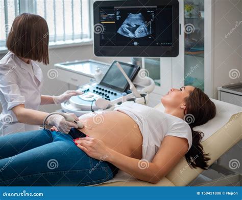 Pregnant Woman On Utltrasonographic Examination At Hospital Stock Photo