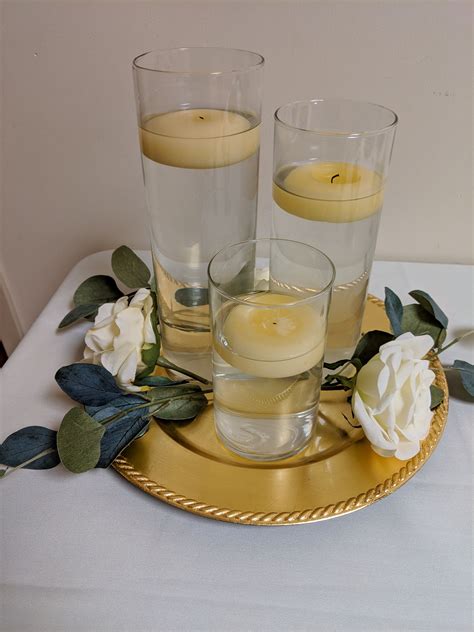 3 Piece With Ivory Floating Candles On A Gold Charger White Roses And
