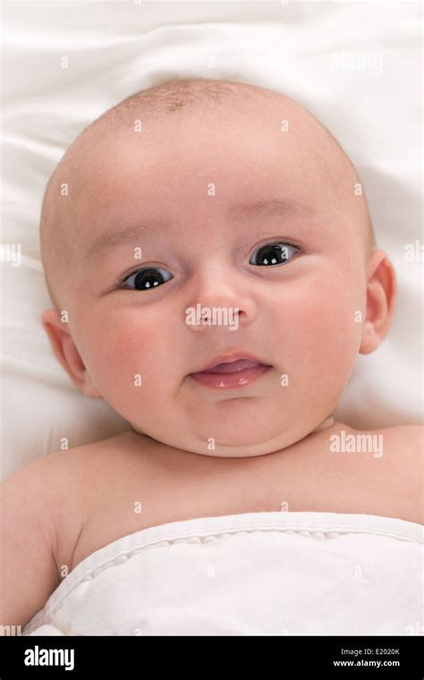 Portrait Of A Happy Baby Lying In Bed Stock Photo Alamy