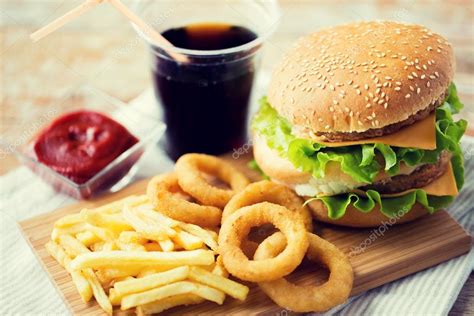 Close Up Of Fast Food Snacks And Drink On Table — Stock Photo © Syda