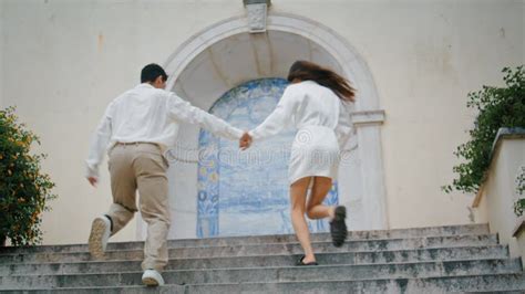 Excited Lovers Running Stairs Positive Man Woman Holding Hands In Azulejo Place Stock Photo