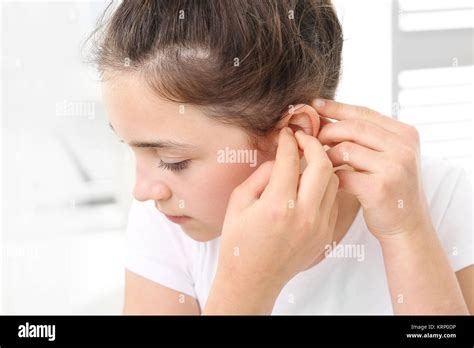 The Girl Assumes Hearing Aid Stock Photo Alamy